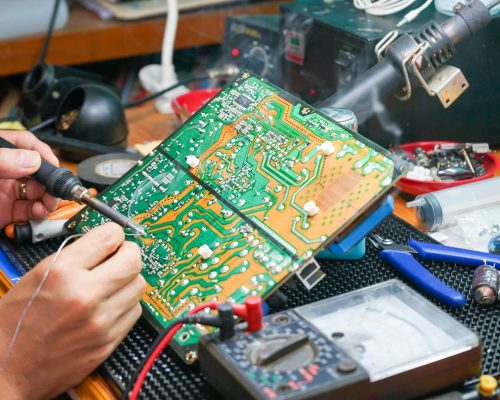 homeguide-tv-technician-repairing-motherboard-and-circuit-board-on-television