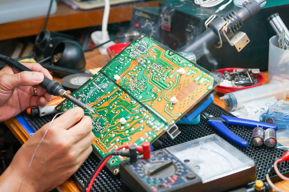 homeguide-tv-technician-repairing-motherboard-and-circuit-board-on-television